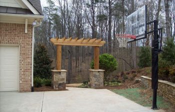 wooden arbor with stone bases by Mobile Joe's Landscaping